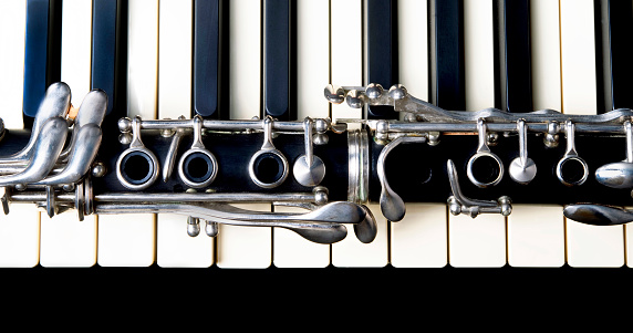 Closeup of a clarinet and keyboard.