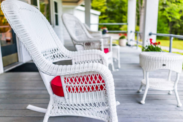 Front porch of house with white rocking chairs on wooden deck Front porch of house with white rocking chairs on wooden deck front porch stock pictures, royalty-free photos & images