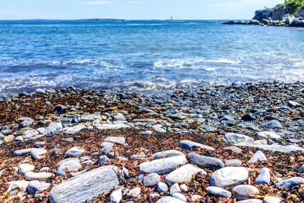 Rocky public beach called Ship Cove by Portland Head Lighthouse in Cape Elizabeth, Maine