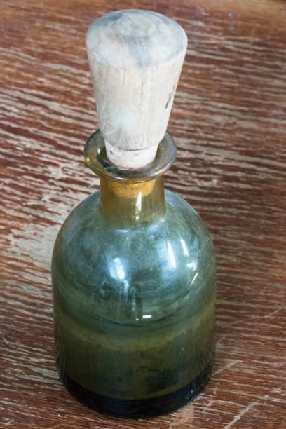 istock Old green glass potion bottle with wooden plug. 836853114