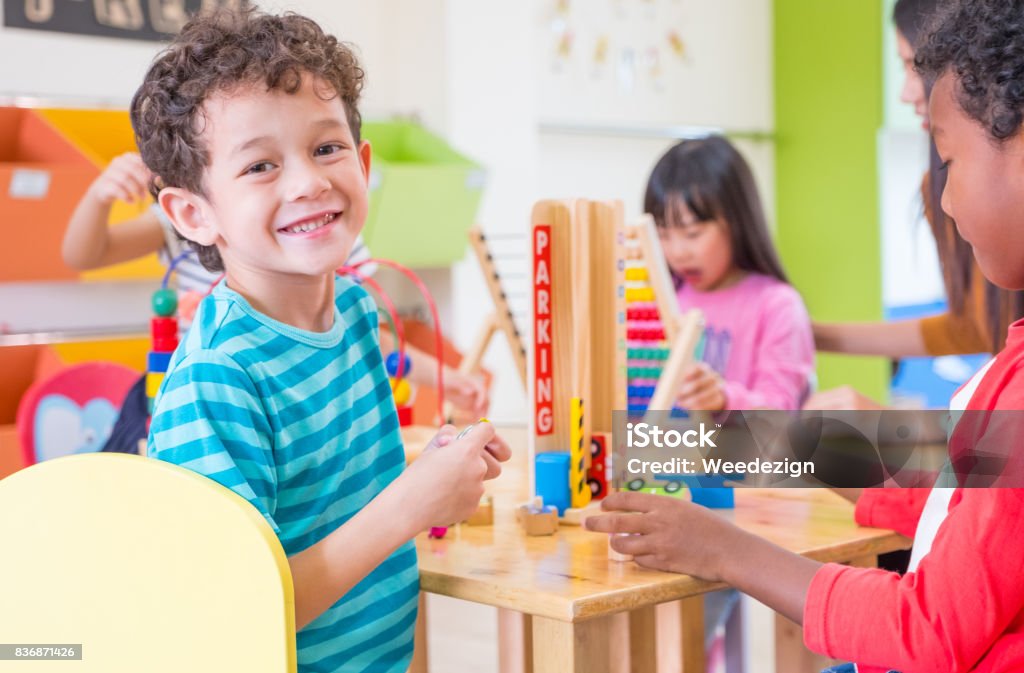 Kindergarten students smile when playing toy in playroom at preschool international,education concept Kindergarten students smile when playing toy in playroom at preschool international,education concept. Child Stock Photo