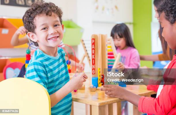 Kindergarten Students Smile When Playing Toy In Playroom At Preschool Internationaleducation Concept Stock Photo - Download Image Now