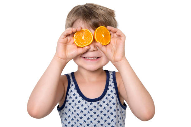 istock Cute Boy With Two Slices Orange On Eyes 836882380