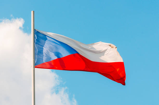 Slovakia flag high up on flagpole, waving on wind.