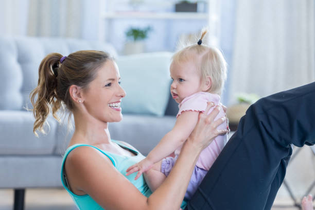 istock Beautiful mom does stomach crunches with toddler in lap 836894390