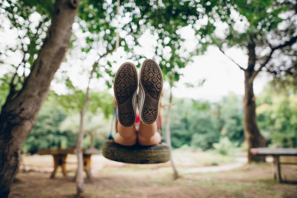istock Girl swinging on traktor tire 836910080