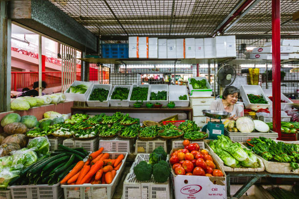 greengrocer shop in a wet market - tomato women green market imagens e fotografias de stock