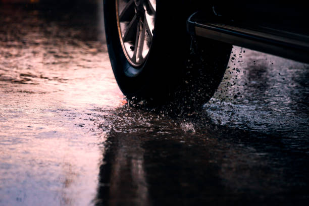istock Motion car in rain big puddle with water splashing from the wheels 836923680