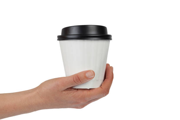 istock Female hand holding a disposable white coffe cup isolated on white background with copy space 836931398