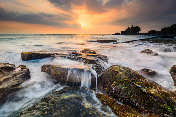 Garden of tanah Lot Tanah lot beach scenery at sunset with the temple as background tanah lot stock pictures, royalty-free photos & images