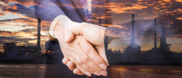 istock Double exposure of handshake and refinery. 836966632