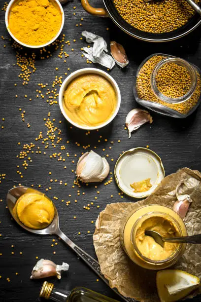 Ingredients for making mustard. On a black chalkboard.