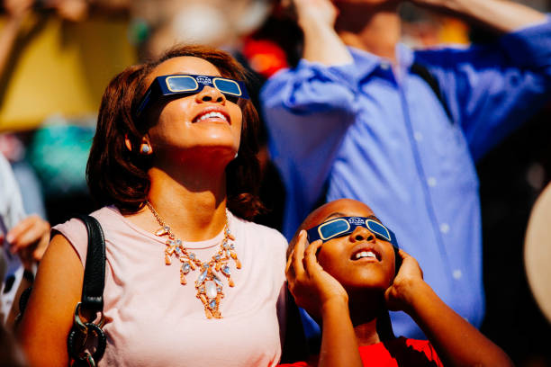 Spectators watching the Solar Eclipse with glasses stock photo