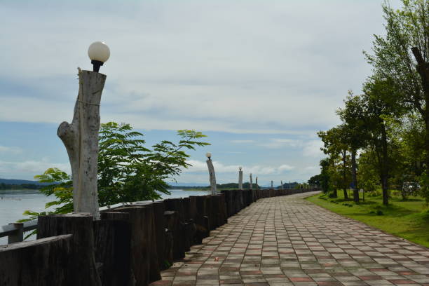 istock walk way at Khong river side in rainny season 837003766