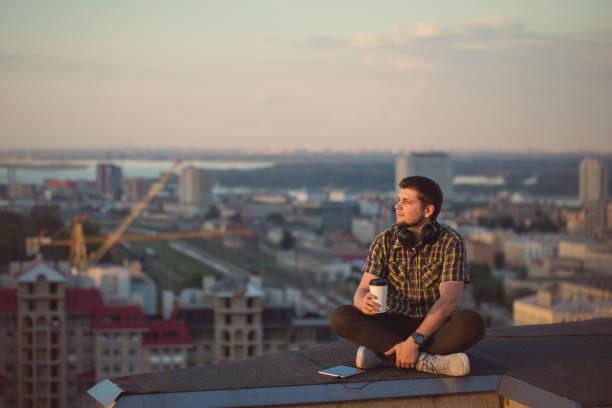 istock Man is listening to music on roof. 837009746