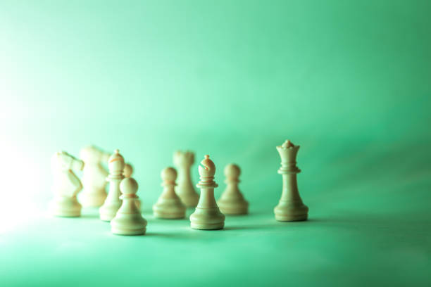 chess pieces with white background illuminated with low light