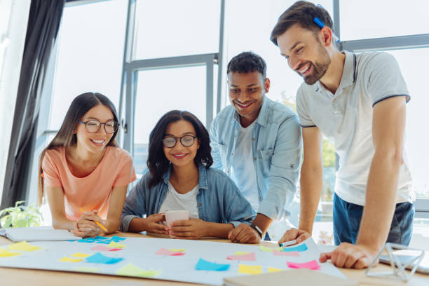 istock Happy young people looking at the poster 837031884