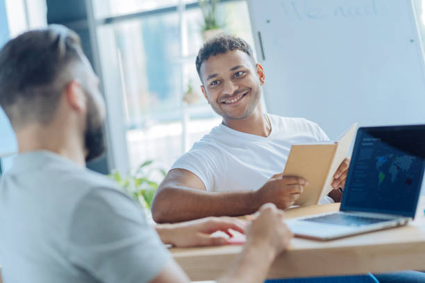 istock Handsome cheerful man looking at his colleague 837037668