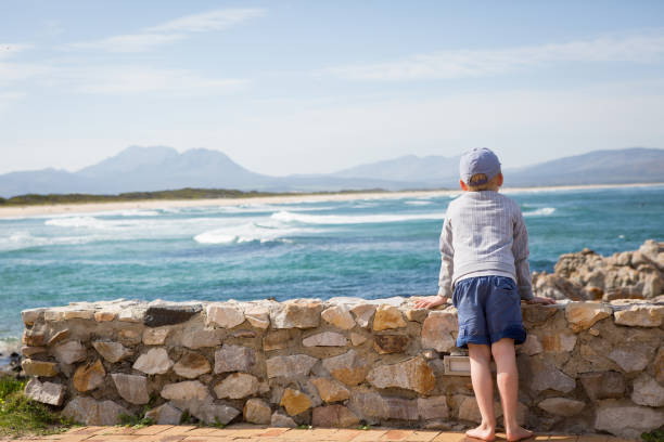 istock Young boy looking out over the sea 837069876