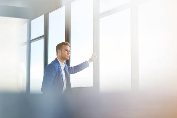 istock Serious young businessman standing in the office 837070020