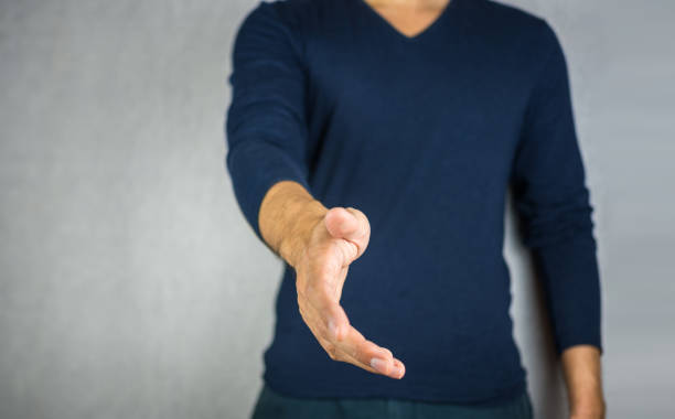 istock reach out hand by man, on light grey background 837070110