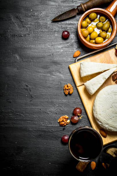 istock Sheep cheese with red wine , nuts and olives. 837074332