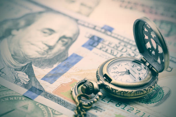 classic pocket watch on a hundred us dollar bill. - length imagens e fotografias de stock