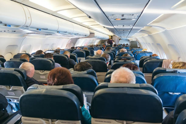 istock back view of passengers on chairs inside aircraft 837106954