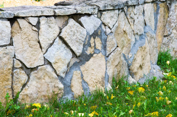 istock Texture, pattern, background. Autumn leaves, Granite stones. Sandstone, put a fence flowerbeds. sedimentary rock consisting of sand or quartz grains cemented together, typically red, yellow, or brown in color. 837114242