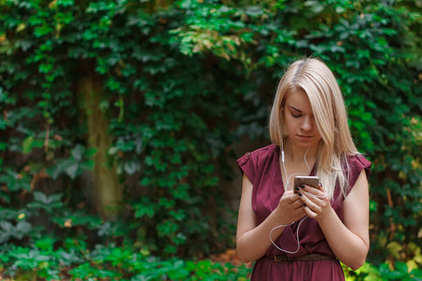 istock Young attractive woman is texting with her smartphone 837125488