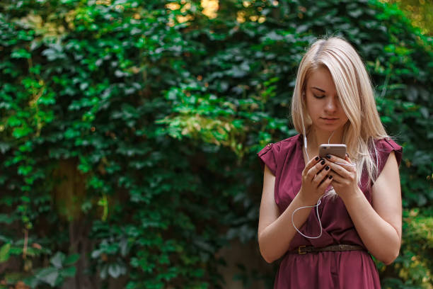 istock Young attractive woman is texting with her smartphone 837125852