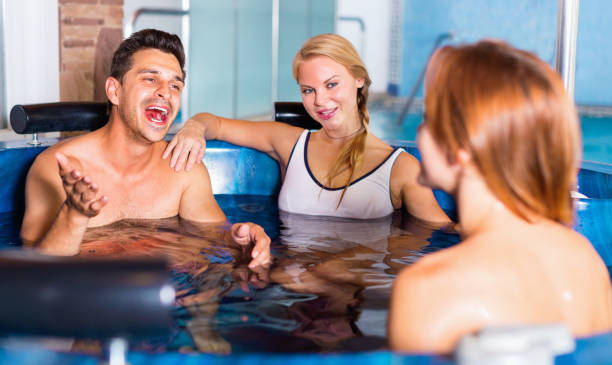 istock Three friends are resting in pool in time spa-day in salon. 837134104