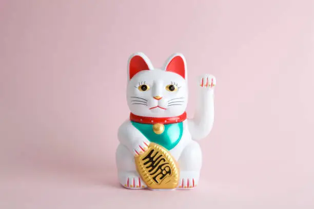 a Maneki-neko plastic cat, Symbolizing luck and wealth, on a pop and colorful background."nMinimal color still life photography