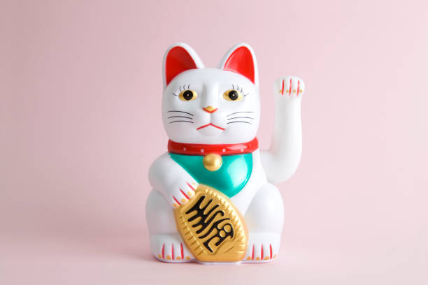 Colorful Maneki Neko a Maneki-neko plastic cat, Symbolizing luck and wealth, on a pop and colorful background."nMinimal color still life photography maneki neko stock pictures, royalty-free photos & images