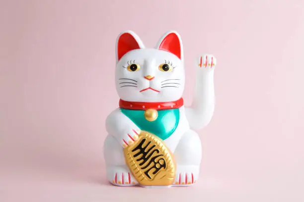 a Maneki-neko plastic cat, Symbolizing luck and wealth, on a pop and colorful background."nMinimal color still life photography