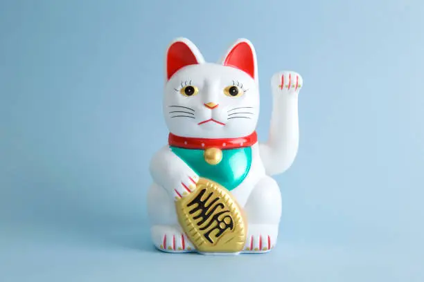 a Maneki-neko plastic cat, Symbolizing luck and wealth, on a pop and colorful background."nMinimal color still life photography