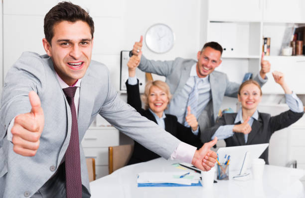 istock Smiling businessman and team delighted with achievements 837144014
