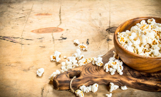 istock Popcorn in a wooden bowl on the Board. 837148386