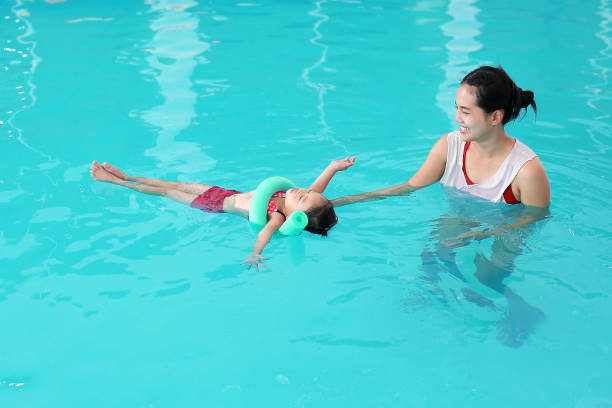 istock Mother with baby in swimming pool training. 837151904