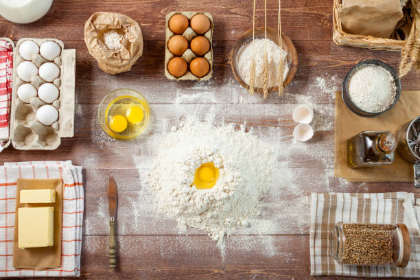 istock Egg yolk in flour on a wooden table in a bakery. Rural or rustic style. Top View 837154116