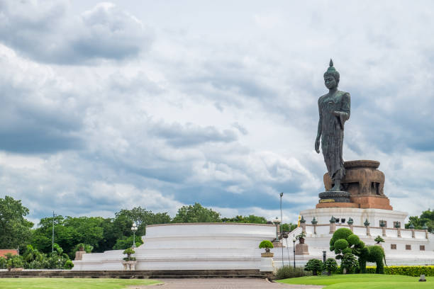istock Buddha statue beside in decorated garden 837165246