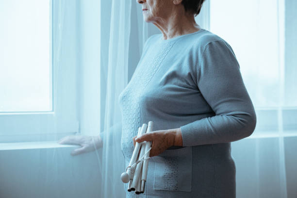 istock Blind woman holding white cane 837175154