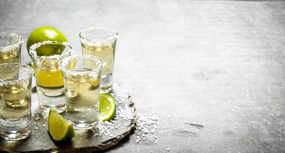 Tequila with lime and salt. On the stone table.