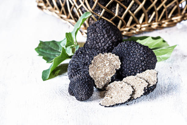 istock Expensive  black truffles - gourmet mushrooms on rustic white table with free text space. Selective focus. 837178498