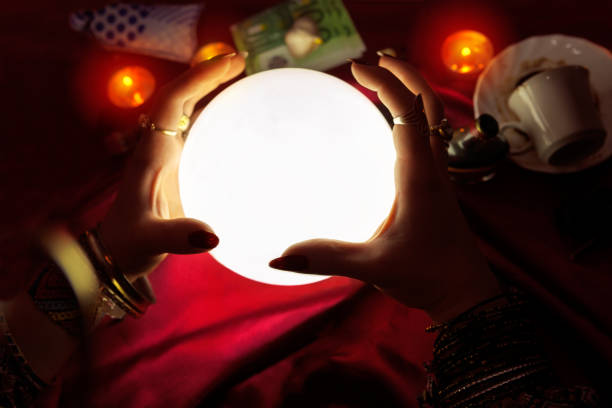 istock Hands of fortune teller with crystal ball in the middle 837178834