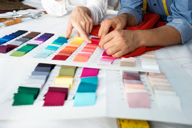 Fashion Designers Fashion designers are choosing fabric and color for their new collection. textile industry stock pictures, royalty-free photos & images