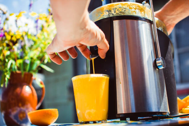 Preparation of juice from an orange stock photo