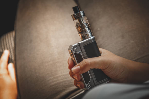 Modern vape device or electronic ciggarette in yuong girl hand