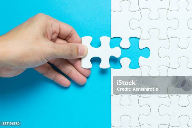 White Jigsaw Puzzle Stock Photo - Download Image Now - Jigsaw Puzzle, Hand, Jigsaw