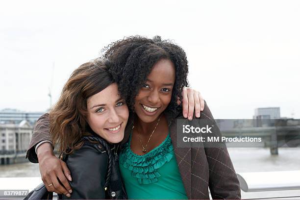 Friends Posing By River Thames Stock Photo - Download Image Now - 20-24 Years, 25-29 Years, Adults Only